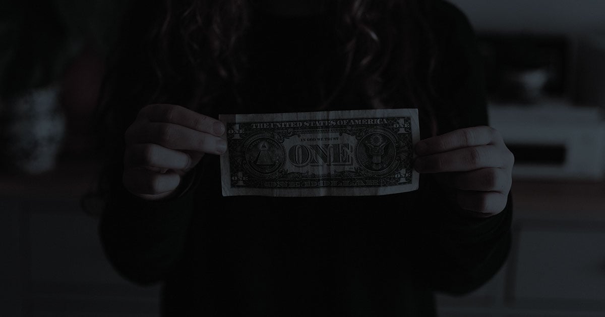 woman holding dollar bill